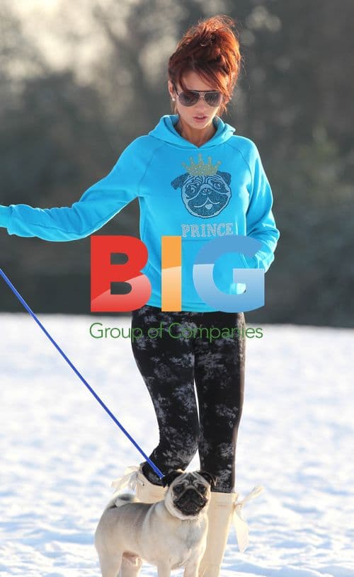 Amy Childs and cousin playing in snow with pet pug