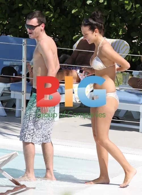 Tulisa and assistant relax by Miami hotel pool