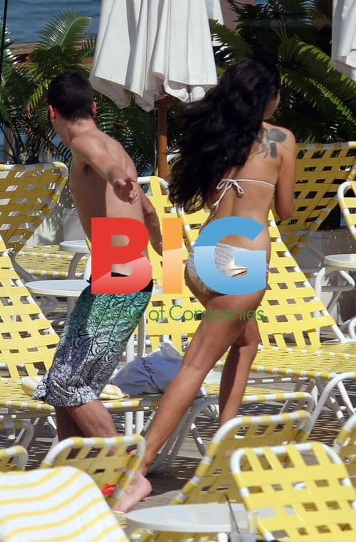 Tulisa and Assistant Relaxing by Pool