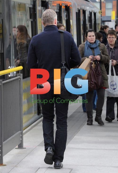 Rory Bremner taking tram in Manchester