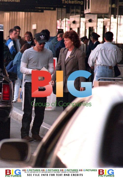 Brad Pitt Hides from Fans at Airport