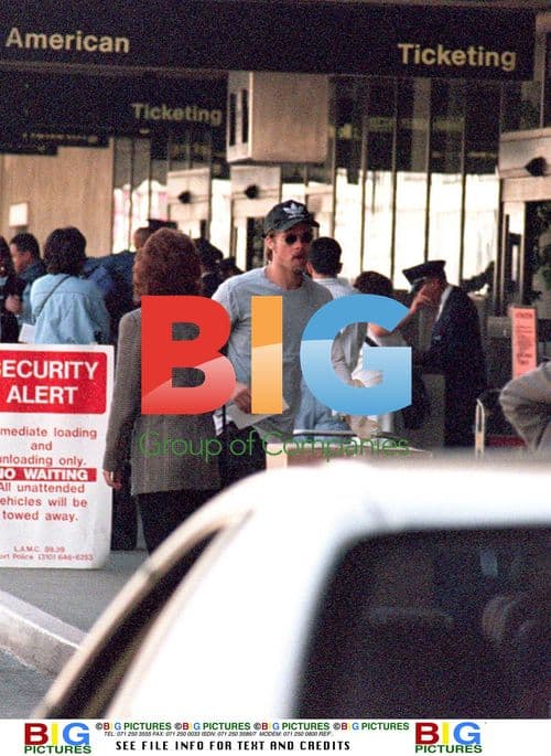 Brad Pitt Tries to Hide From Fans at LAX