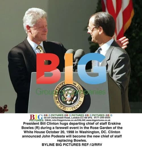 Clinton hugs departing Chief of Staff Bowles