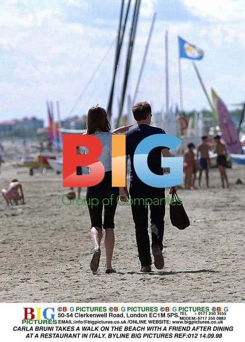 Carla Bruni Takes Beach Walk in Italy