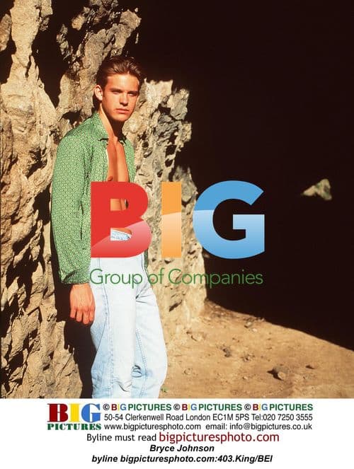 Bryce Johnson poses casually in green shirt