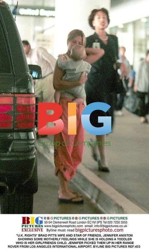 Jennifer Aniston holding toddler