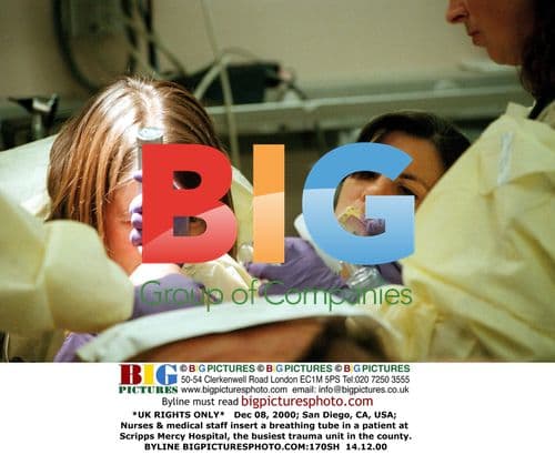 Nurses insert breathing tube in patient at hospital