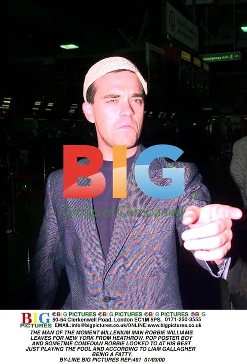 Robbie Williams Departs Heathrow for New York