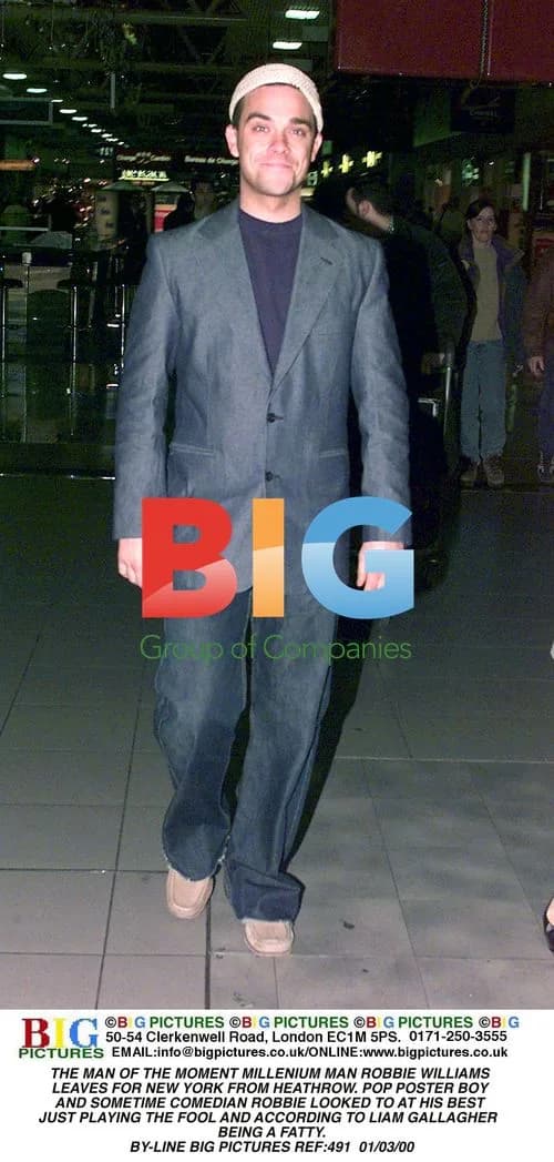Robbie Williams Departs Heathrow for New York