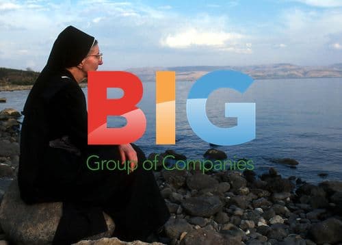 Catholic nun meditates by Sea of Galilee