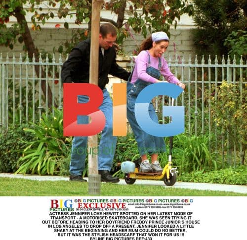 Jennifer Love Hewitt on motorized skateboard