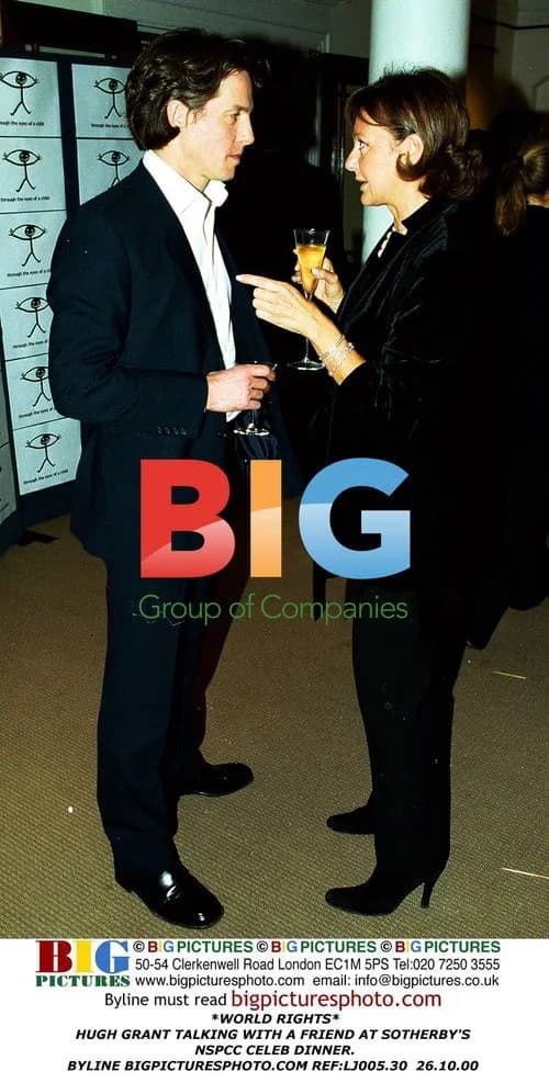 Hugh Grant talking with friend at NSPCC dinner