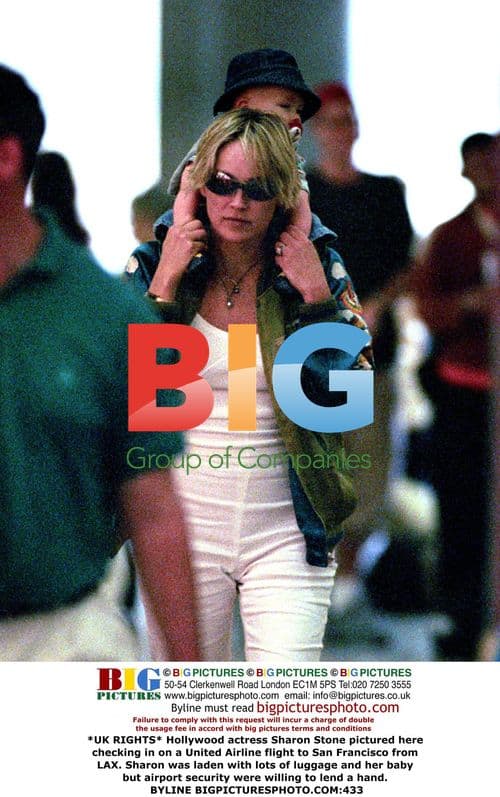 Sharon Stone checks in for SF flight with baby