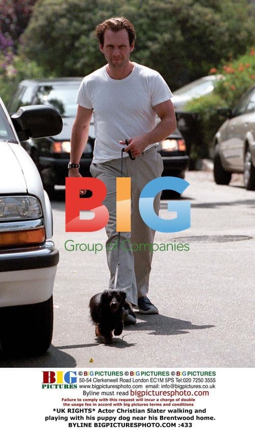Christian Slater out walking his puppy