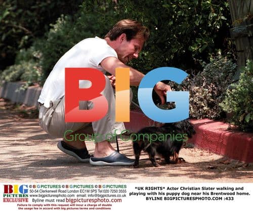 Christian Slater walking with puppy