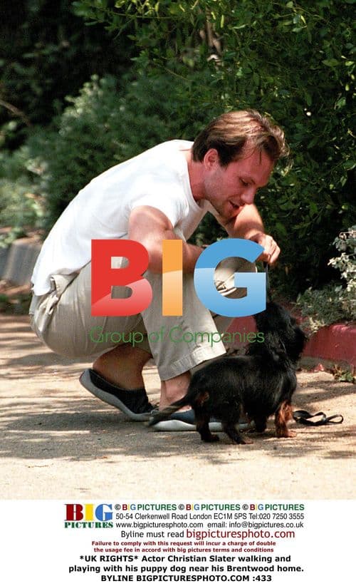 Christian Slater plays with puppy near home