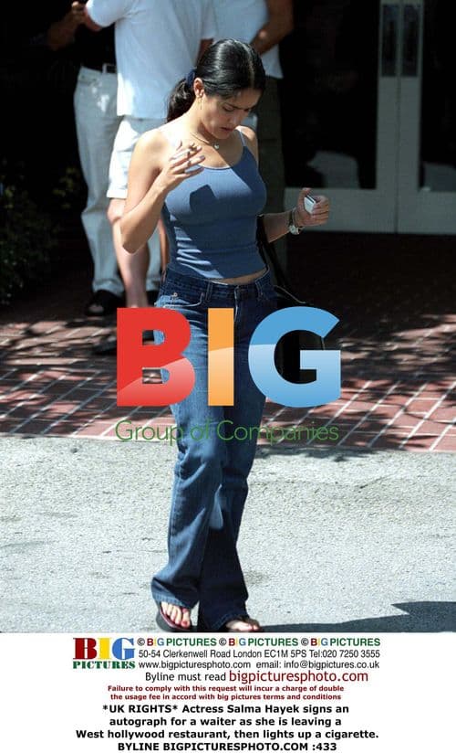 Salma Hayek signs autograph, smokes cigarette