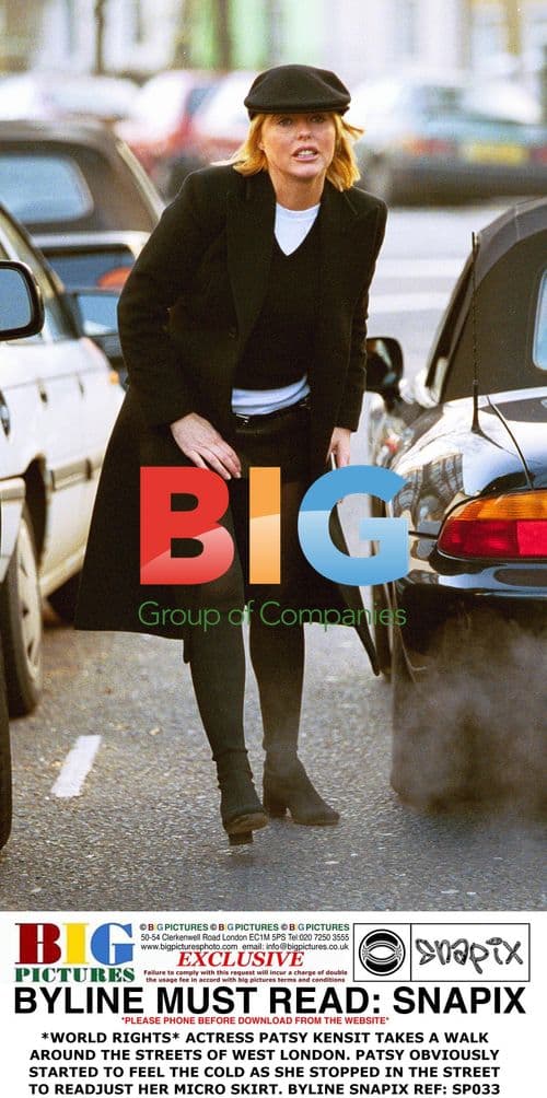 Patsy Kensit Adjusts Micro Skirt on Street