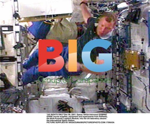 Astronaut Dominic Gorie moves supplies on ISS