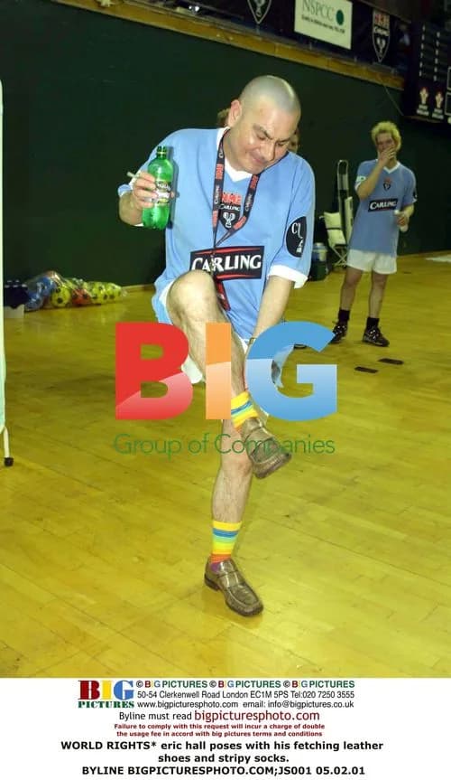 Eric Hall poses in leather shoes and stripy socks