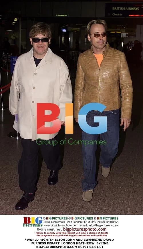 Elton John and David Furness depart Heathrow