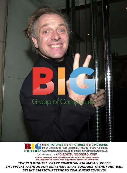 Comedian Rik Mayall poses in London