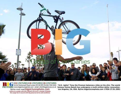 Tony the Fireman balances bike on chin