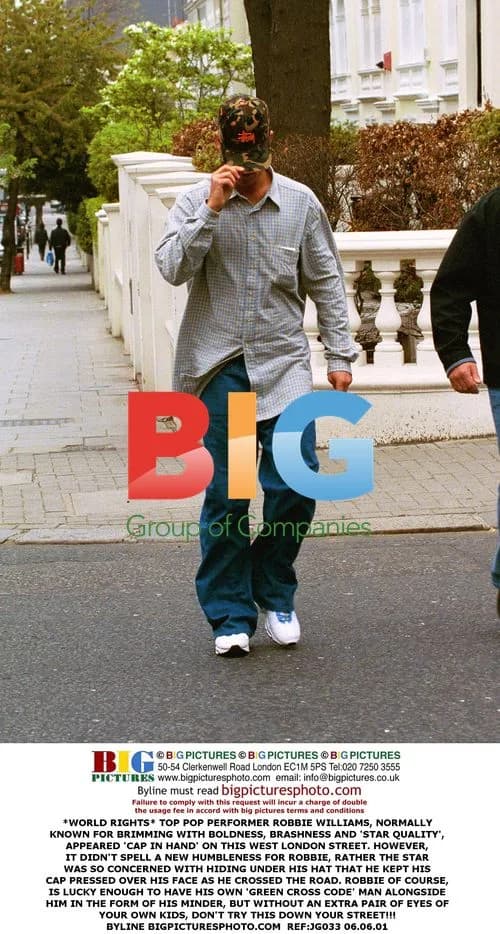 Robbie Williams Hiding Under Cap in West London