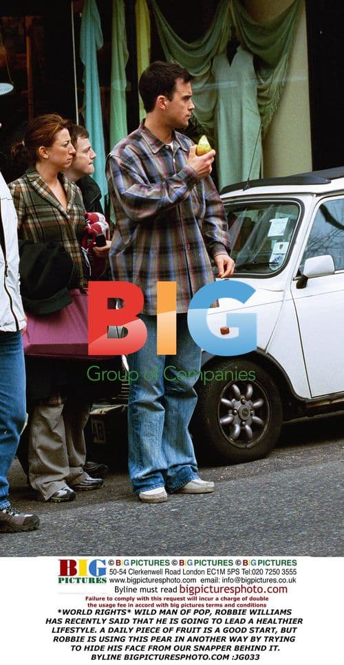 Robbie Williams Hides Behind Pear