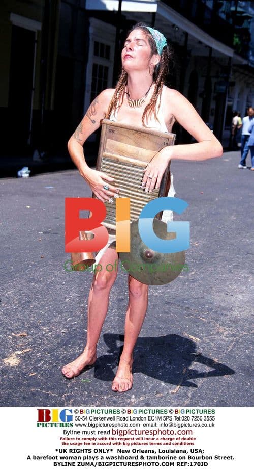 Barefoot woman plays music on Bourbon Street