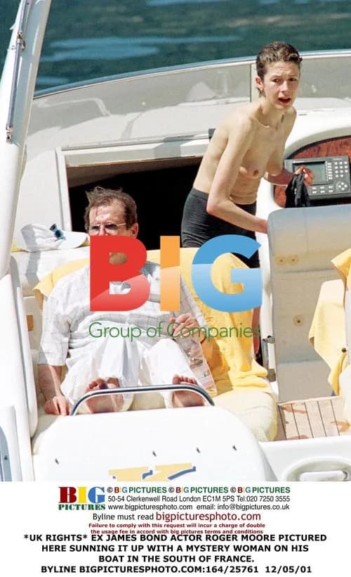 Roger Moore Relaxing on Boat with Mystery Woman