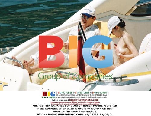 Roger Moore Relaxes with Mystery Woman on Boat in France