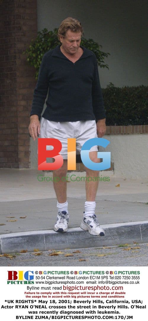 Ryan O'Neal crosses street in Beverly Hills