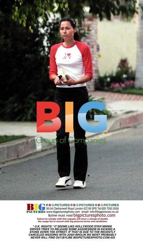 Minnie Driver kicks stone on street