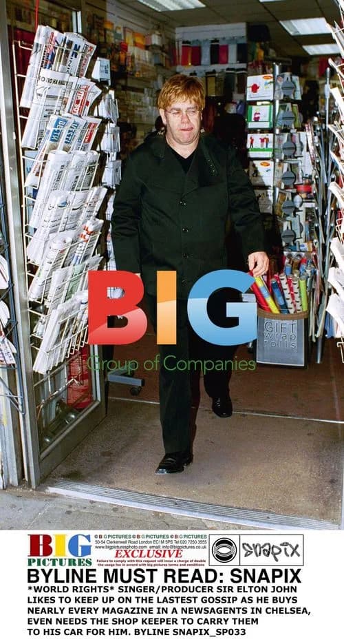 Elton John Buys Magazines at Newsagents