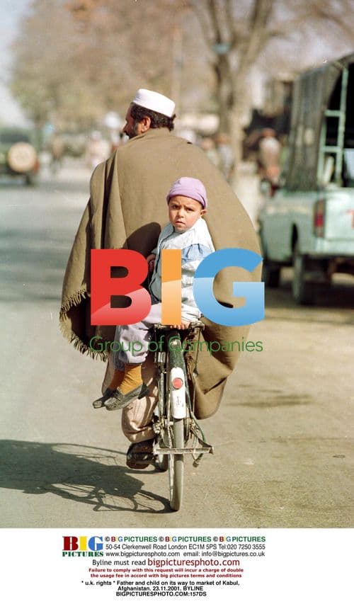 Father and child on their way to market in Kabul