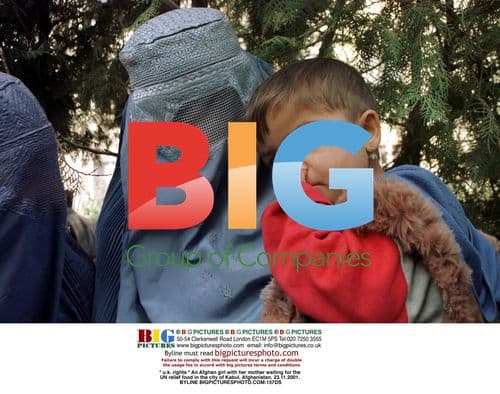 Afghan girl and mother wait for UN food aid