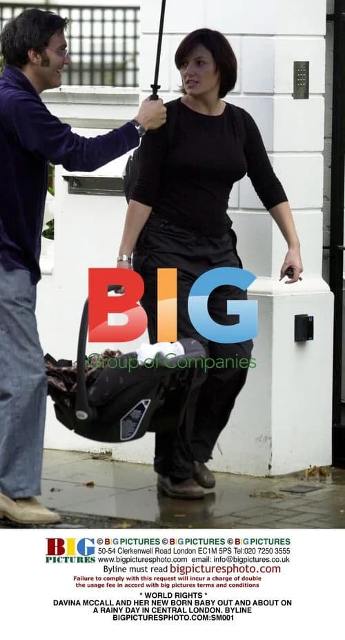 Davina McCall and her newborn baby out in London rain