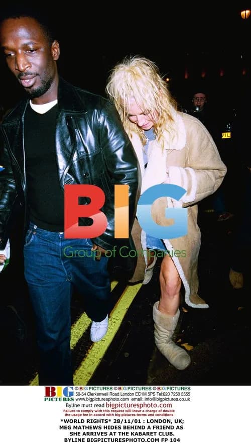 Meg Mathews hides behind friend at Kabaret Club