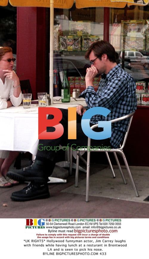 Jim Carrey laughing with friends at Brentwood restaurant