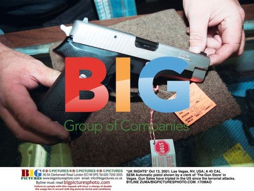 Gun Store Clerk Shows Semi-Automatic Pistol