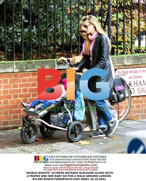 Natasha McElhone walks with friend and baby in London