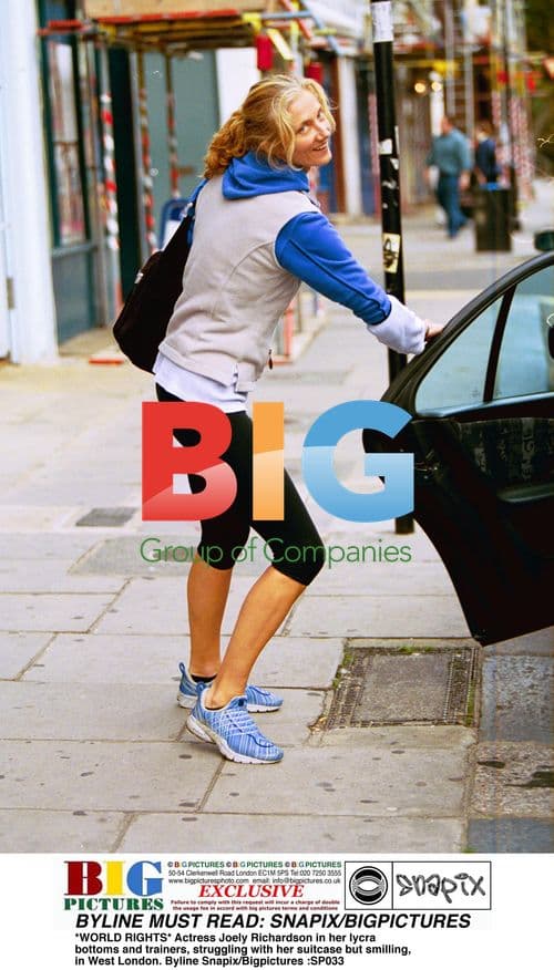 Joely Richardson struggles with suitcase in West London