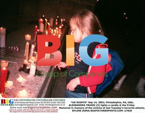 Girl Lights Candle at 9/11 Memorial
