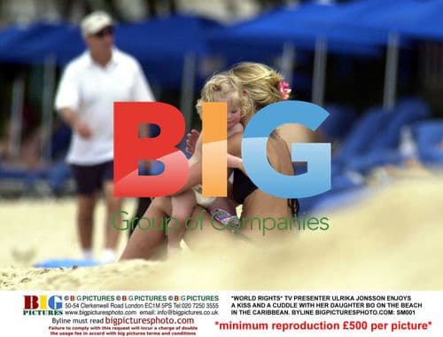 Ulrika Jonsson Cuddles Daughter on Caribbean Beach