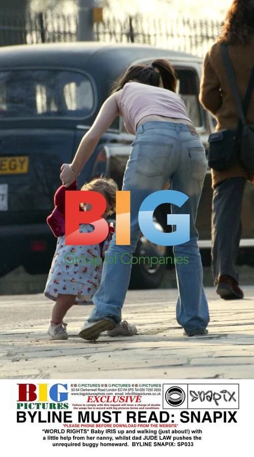 Baby IRIS walks with nanny as Jude Law pushes empty buggy