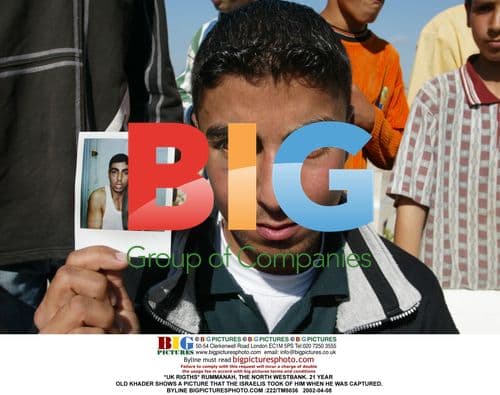 Palestinian Man Shows Arrest Photo