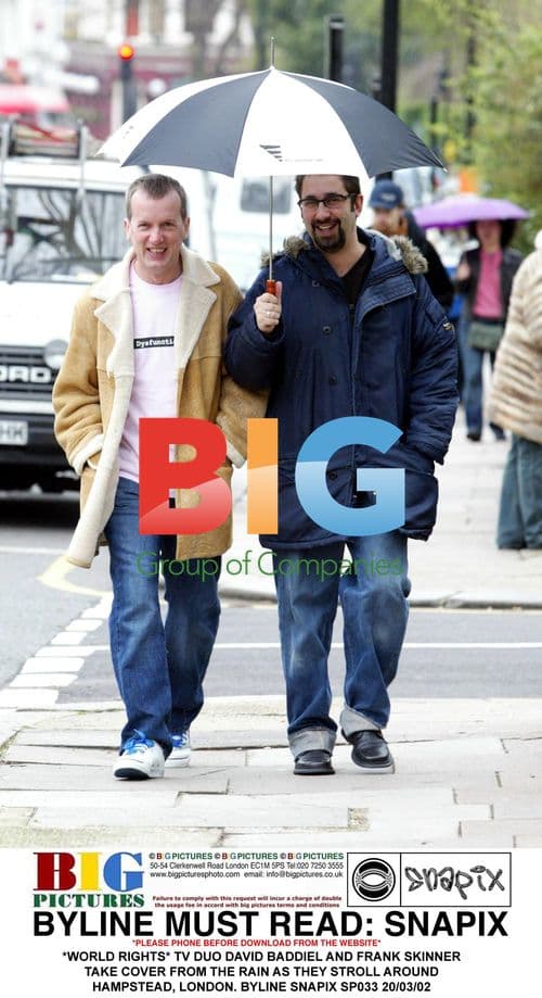 TV Duo Baddiel and Skinner Brave the Rain in London