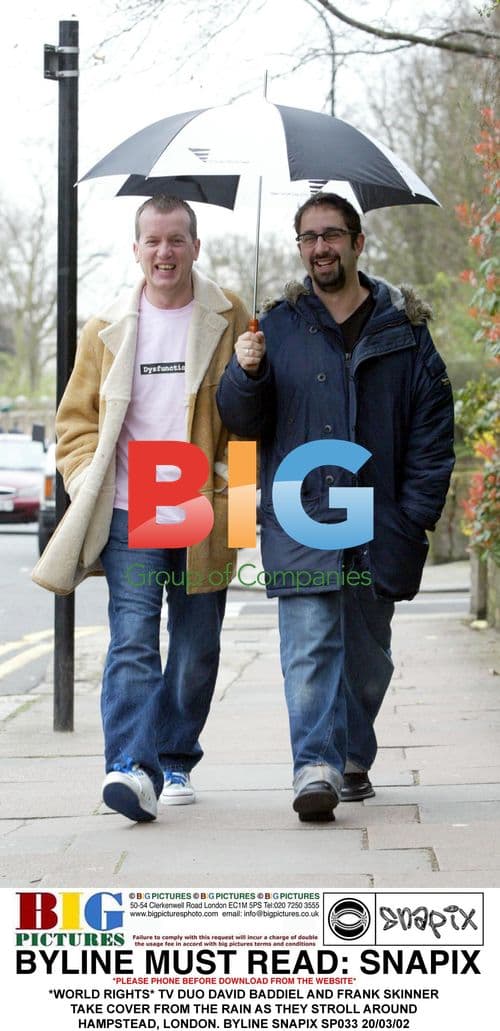 David Baddiel and Frank Skinner take cover from rain in London