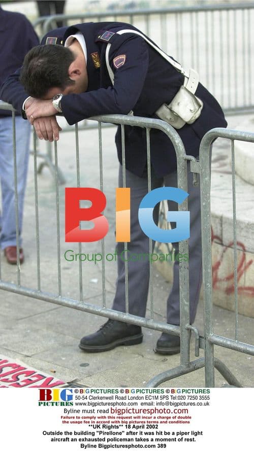 Policeman Takes Moment of Rest After Milan Plane Crash